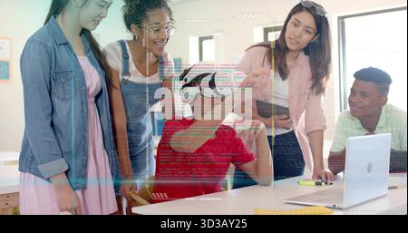 Interacting teen in red shirt wearing VR headset exploring VR content in classroom with instructor Stock Photo