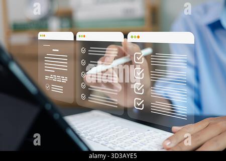 Businessman using stylus to manage digital checklist on laptop, concept of task management, productivity, workflow organization and online project pla Stock Photo