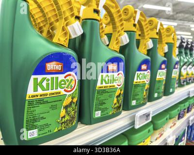 Calgary, Alberta, Canada. Apr 8, 2025. A shelf in a store is stocked with green spray bottles of Ortho Killex lawn weed control, featuring yellow spra Stock Photo