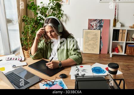 Woman with a white forelock engages in digital art creation at home, surrounded by creativity. Stock Photo