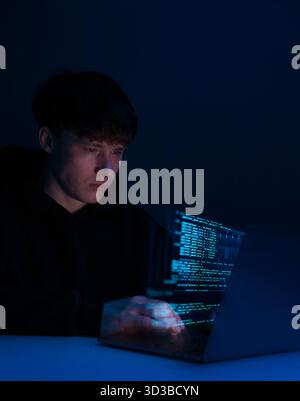 programmer working on laptop, hacker, glowing floating code, merging digital and physical world, augmented reality, cyber security, hacking, software Stock Photo