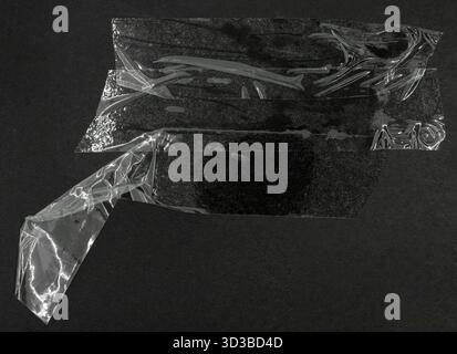 Matte plastic adhesive tape on grunge black background Stock Photo