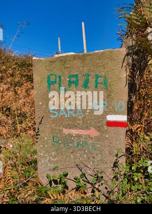 Basque Country, France - Oct 11 2025: Hand-painted GR10 marker on a stone post along the Pyrenees trail in the French Basque Country near Sare, France, captured under a clear autumn sky. Stock Photo