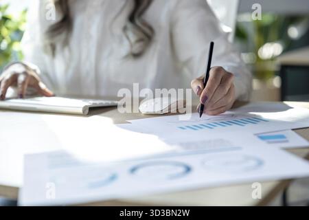 Business project. Close up of a woman making notes and working with schemes Stock Photo