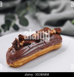 Food, Eclair with Chocolate Cream and Hazelnuts Stock Photo