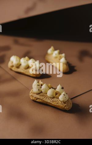 Food, Eclairs with whipped cream and hazelnuts Stock Photo