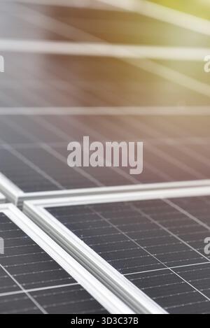 Black solar panels, close up view. Small drops of water on the surface of the panels after rain. Industrial background with copy space Stock Photo