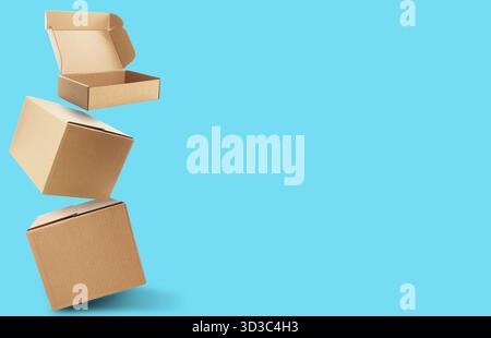 Cardboard boxes in air on light blue background. Banner design with space for text Stock Photo