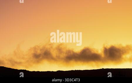 Cumulus and Stratus clouds in dramatic sunset sky over Cape Town Stock Photo