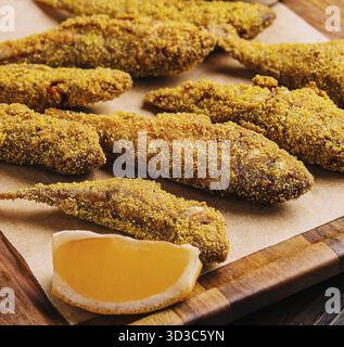 Food, Fried smelt on a wooden chopping board Stock Photo