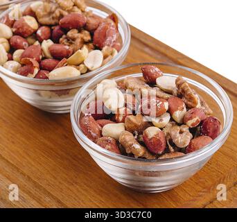 Food, Assorted nuts in a glass bowls on wooden Stock Photo