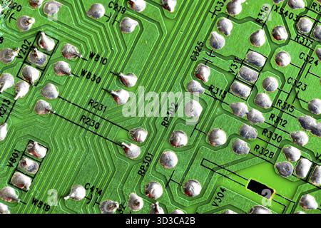 Macro Close up of printed wiring on old green PC circuit board Stock Photo