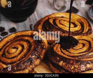 Food, Sweet chocolate cinnamon rolls on wood Stock Photo