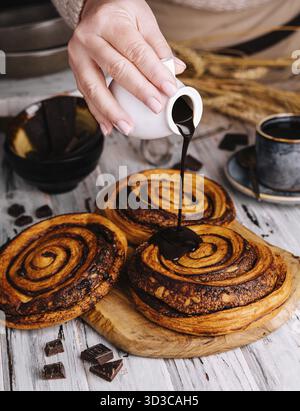 Food, Sweet chocolate cinnamon rolls on wood Stock Photo