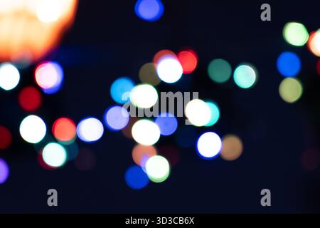A soft-focus image showing a beautiful mix of blue, teal, and purple bokeh lights, creating a dreamy and abstract background perfect for festive, crea Stock Photo