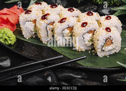 Food, Set of fresh sushi rolls with salmon, avocado and sesame seeds Stock Photo