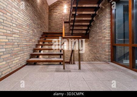 interior staircase with tiles, bricks and wood Stock Photo