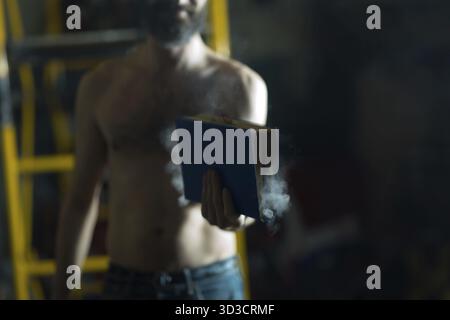 Man hold burning book in his hands Stock Photo