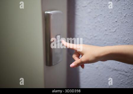 A video displaying a closeup view of someone pushing elevator buttons in an office building Stock Photo