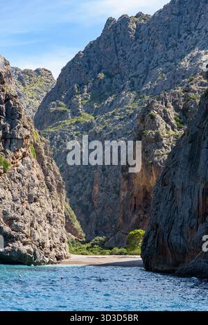 Stunning view of the narrow Torrent de Pareis gorge leading to a hidden beach surrounded by towering limestone cliffs on the island of Mallorca, Spain Stock Photo