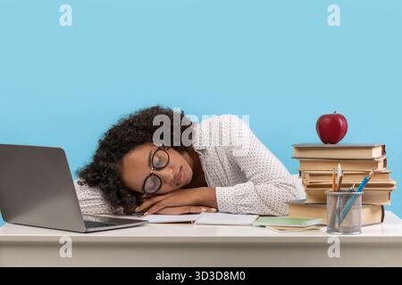 Young Black Female Student Sleeps While Studying for Online Exam at Home Stock Photo