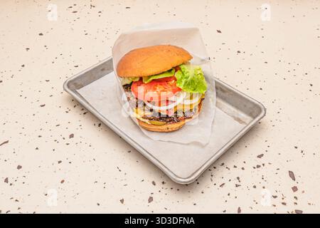 Beef burger with Provolone cheese, salami, and olives on Italian bread Stock Photo