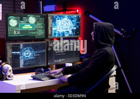 Hacker typing on keyboard, running neural network software to breach company security and open locked databases. Rogue engineer doing cyber attacks, operating machine learning hacking platforms Stock Photo
