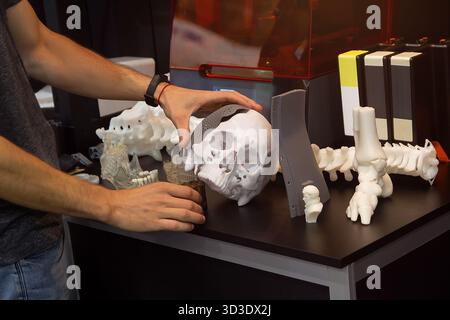 A man holds samples of products made using 3D printing technology. Industry Stock Photo