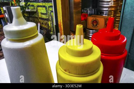Sauce dispenser ketchup mayonnaise and mustard in Playa del Carmen Quintana Roo Mexico Stock Photo