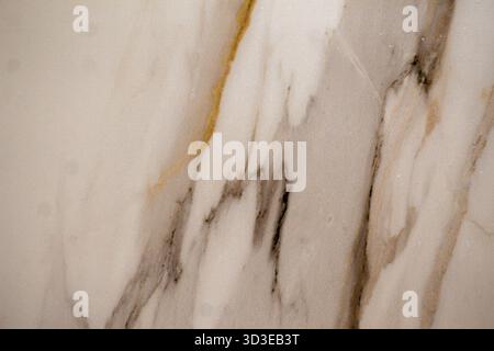 Detailed texture of polished marble showing unique golden and gray vein patterns. Perfect for design and architecture. Stock Photo