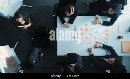 Top down aerial view of professional diverse business team present project and turn around to clap hands or applause to celebrate successful project Stock Photo