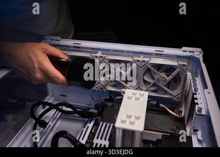 Cleaning the computer video card from dust with a brush and air. Computer fans in dust Stock Photo