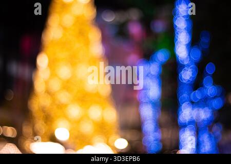 Bokeh lights abstract background gold blue. A vibrant holiday composition featuring large, blurred circles of warm golden lights forming a Christmas t Stock Photo