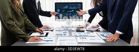 Panorama shot analyst team utilizing BI Fintech to analyze financial report with laptop. Businesspeople analyzing BI data dashboard displayed on Stock Photo