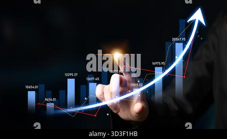 A professional hand interacts with a glowing upward graph on a dark background, symbolizing business growth and positive performance trends in finance Stock Photo