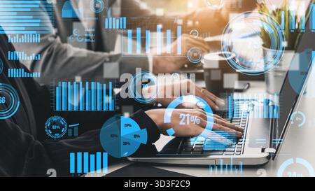 A captivating image of professionals analyzing data on a laptop, surrounded by various charts and graphs, capturing the essence of teamwork and data Stock Photo