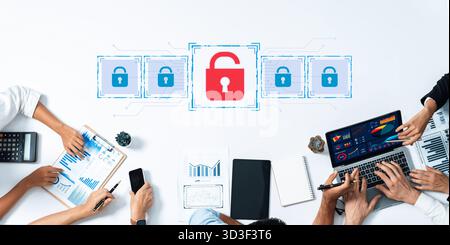 A diverse business team collaborates in a modern office, analyzing data and discussing strategies on security and privacy, represented by digital lock Stock Photo