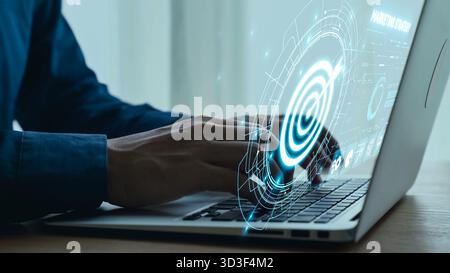Man Typing on Laptop with Digital Interface Displaying Technology and Data Analytics in Modern Office Environment. Qubit. Stock Photo