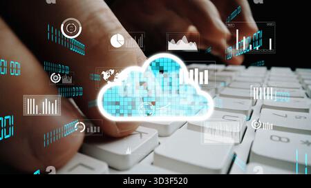 A close-up view of hands typing on a keyboard with cloud computing icons and data graphs overlaid, representing digital technology and modern Stock Photo