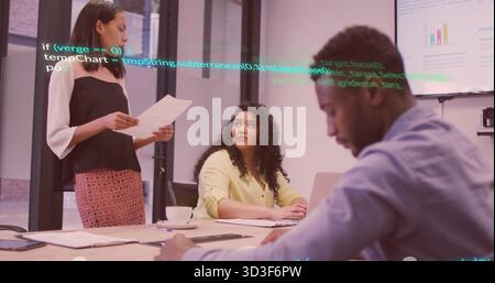 Presenting woman in blouse holding document at meeting table, with laptop, bar chart, code overlay Stock Photo