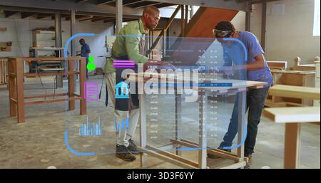 Two carpenters inspecting panel on bench in shop, with measuring tape and holographic overlay Stock Photo