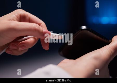 female Hand charges Charge your phone. Close up USB Type-C Stock Photo