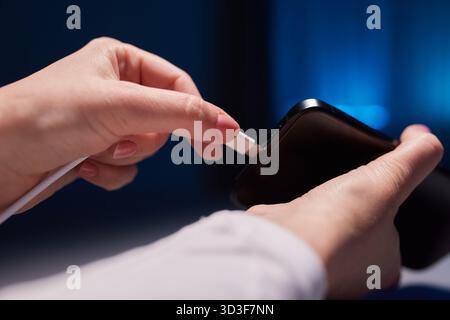 female Hand charges Charge your phone. Close up USB Type-C Stock Photo