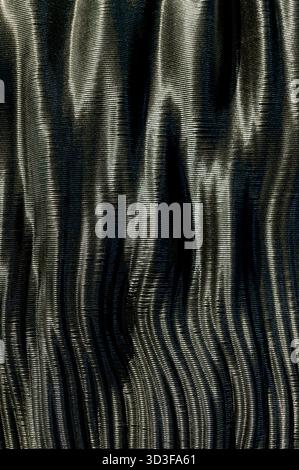 Black carbon fiber texture showing ribbed pattern with subtle highlights and shadows Stock Photo