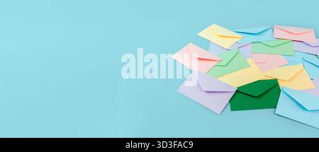 Multicolor envelopes on a blue background, a place for text, the concept of messages and subscriptions Stock Photo