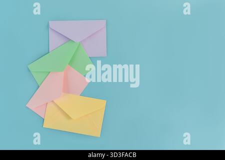 Multicolor envelopes on a blue background, a place for text, the concept of messages and subscriptions Stock Photo