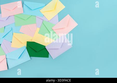 Multicolor envelopes on a blue background, a place for text, the concept of messages and subscriptions Stock Photo