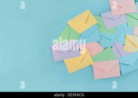 Multicolor envelopes on a blue background, a place for text, the concept of messages and subscriptions Stock Photo