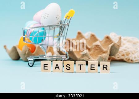 Easter colored eggs and the inscription "Easter" on a monochrome background, a place for text Stock Photo
