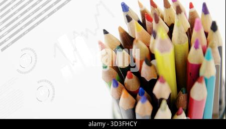 Cluster of colored pencils standing upright in container in studio, with chart overlays, copy space Stock Photo